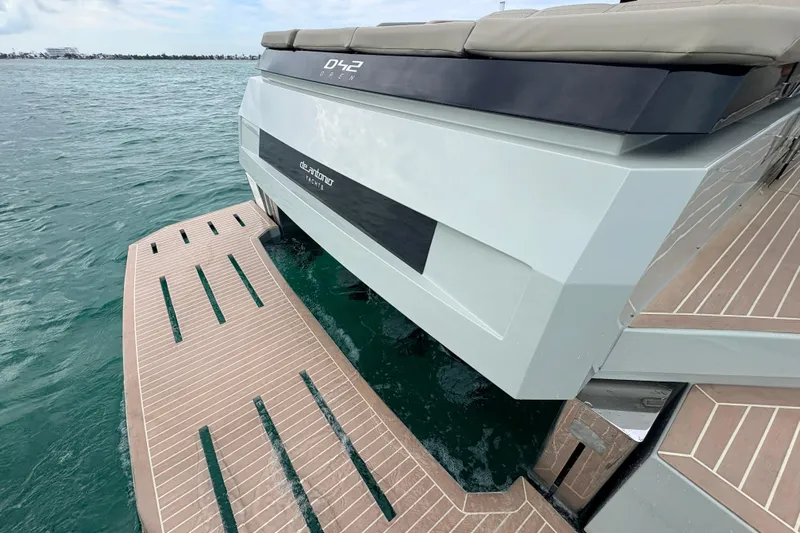 2025 De Antonio Yachts D42 @ Cancun Yacht Photos Pics 2025 De Antonio Yachts D42, rear view on water, showcasing sleek design and swim platform.