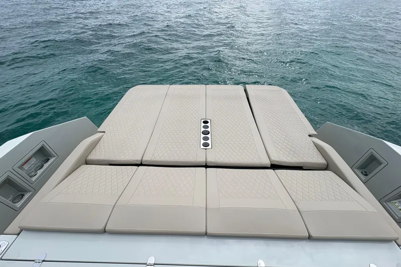 2025 De Antonio Yachts D42 @ Cancun Yacht Photos Pics Luxury sunbed on 2025 De Antonio Yachts D42, overlooking serene ocean waters.