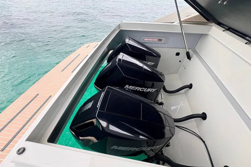 2025 De Antonio Yachts D42 @ Cancun Yacht Photos Pics 2025 De Antonio Yachts D42 with triple Mercury outboard engines on turquoise water.