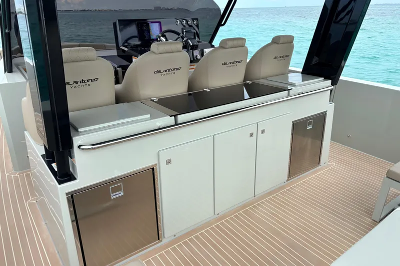 2025 De Antonio Yachts D42 @ Cancun Yacht Photos Pics 2025 De Antonio Yachts D42 interior with sleek seating and modern controls, overlooking the ocean.