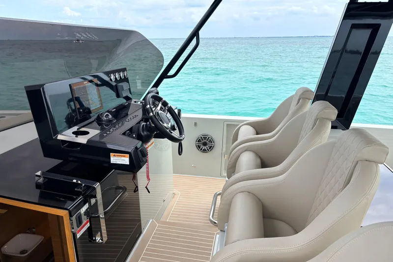 2025 De Antonio Yachts D42 @ Cancun Yacht Photos Pics Helm of 2025 De Antonio Yachts D42 with modern controls and luxurious seating.