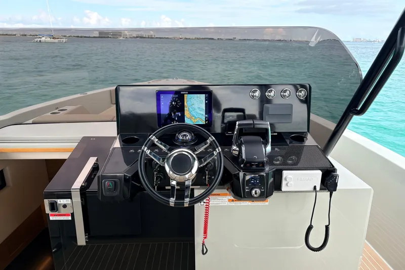 2025 De Antonio Yachts D42 @ Cancun Yacht Photos Pics Helm of 2025 De Antonio Yachts D42 with navigation display and controls, overlooking the ocean.