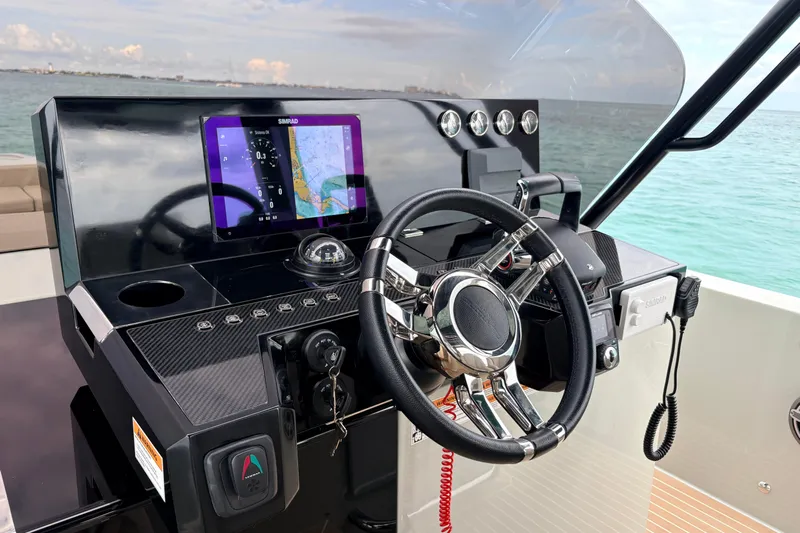 2025 De Antonio Yachts D42 @ Cancun Yacht Photos Pics Helm of 2025 De Antonio Yachts D42 with navigation display and steering wheel.