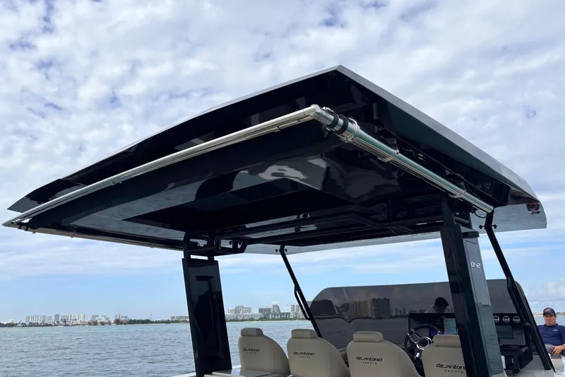 2025 De Antonio Yachts D42 @ Cancun Yacht Photos Pics 2025 De Antonio Yachts D42 with sleek black canopy on open water.