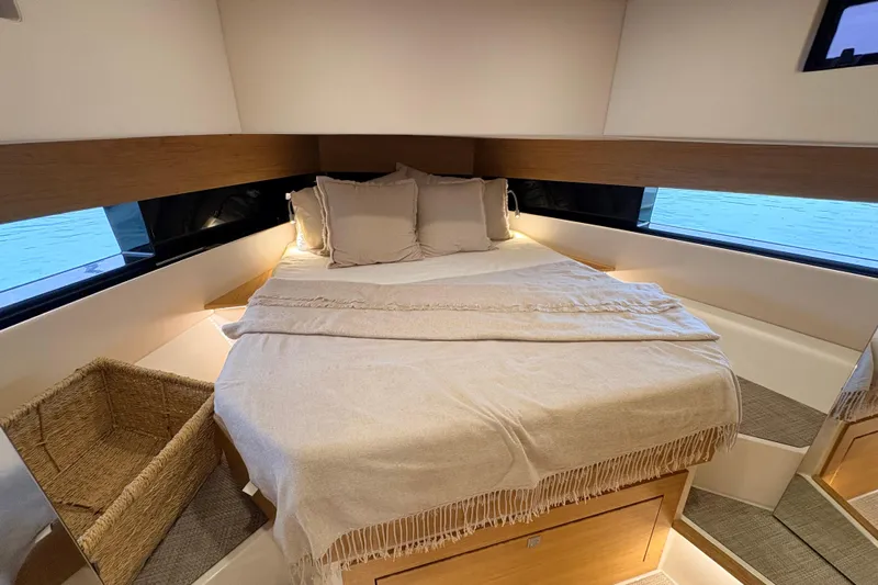 2025 De Antonio Yachts D42 @ Cancun Yacht Photos Pics Luxurious cabin interior of 2025 De Antonio Yachts D42 with cozy bedding and elegant design.