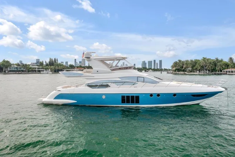  Yacht Photos Pics Azimut 64 Flybridge 2014 yacht on water with city skyline background.