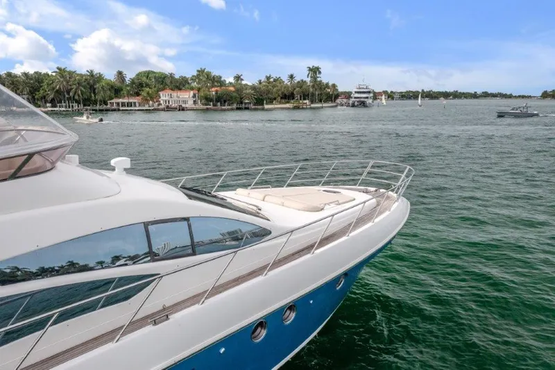  Yacht Photos Pics Azimut 64 Flybridge 2014 yacht cruising on a scenic waterway with palm trees.