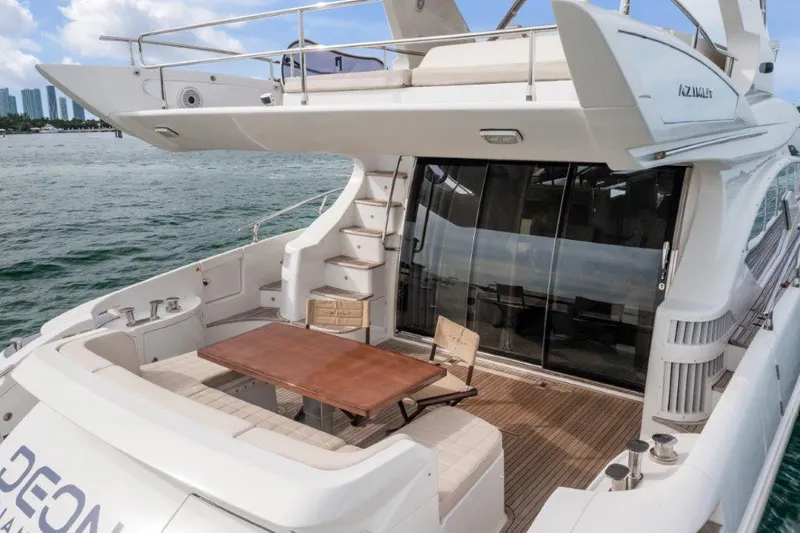  Yacht Photos Pics 2014 Azimut 64 Flybridge yacht with spacious deck and elegant seating area.