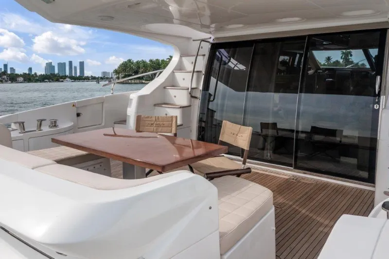  Yacht Photos Pics 2014 Azimut 64 Flybridge yacht deck with seating, table, and city skyline view.