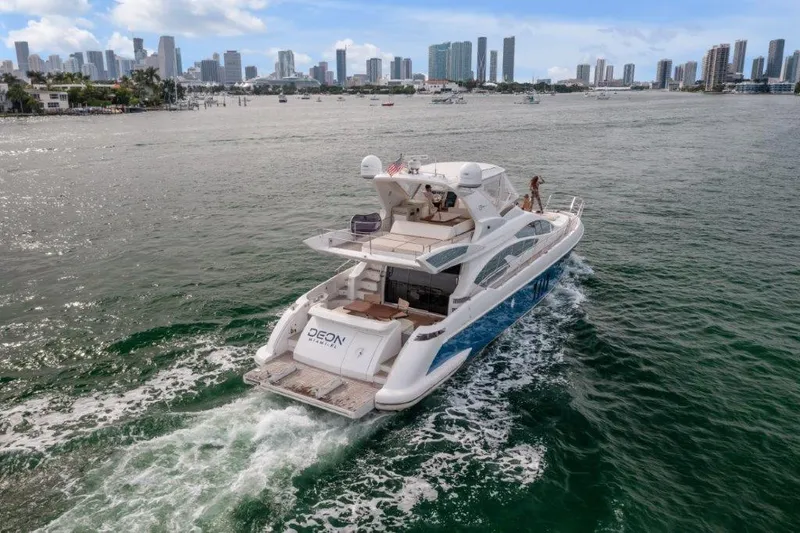  Yacht Photos Pics Azimut 64 Flybridge 2014 yacht cruising near city skyline on a sunny day.