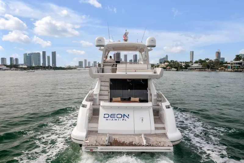  Yacht Photos Pics Azimut 64 Flybridge 2014 yacht cruising in Miami waters with city skyline in background.