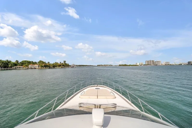  Yacht Photos Pics Bow view of 2014 Azimut 64 Flybridge yacht cruising on a sunny day.
