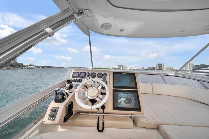  Yacht Photos Pics 2014 Azimut 64 Flybridge yacht helm with modern controls and city skyline view.
