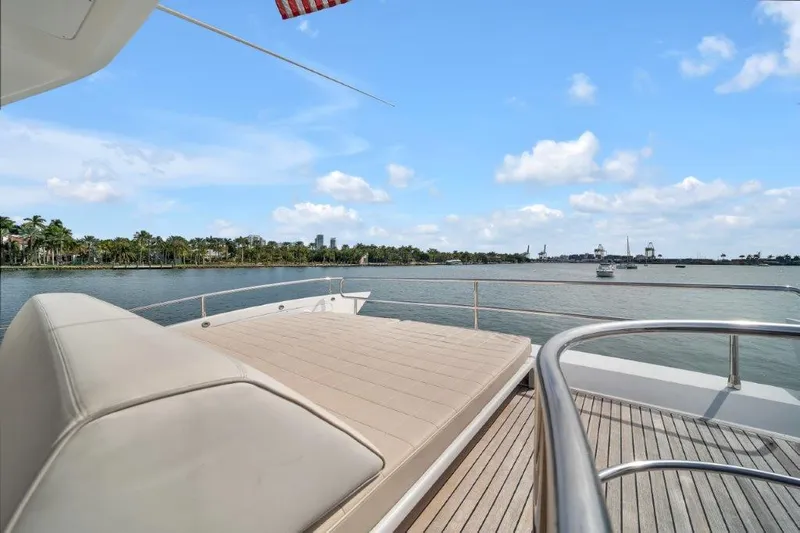  Yacht Photos Pics Luxurious 2014 Azimut 64 Flybridge yacht deck with scenic waterfront view.