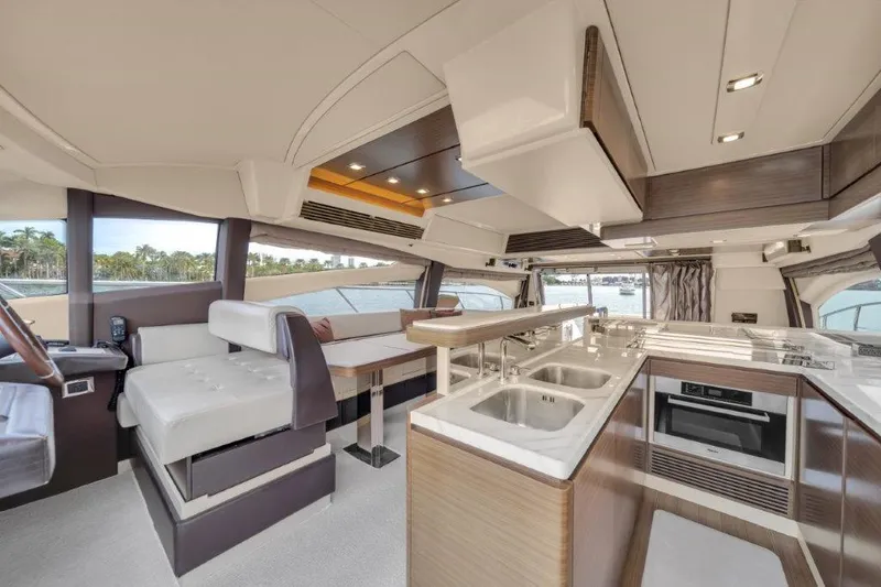  Yacht Photos Pics Luxurious interior of 2014 Azimut 64 Flybridge yacht with modern kitchen and seating area.