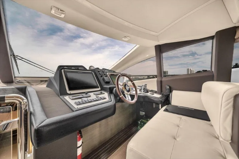  Yacht Photos Pics Luxurious interior of 2014 Azimut 64 Flybridge yacht cockpit with modern controls and seating.