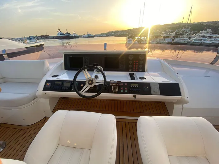 Vixen Yacht Photos Pics Helm of 2011 Princess 85 Motor Yacht at sunset, featuring luxurious seating and controls.