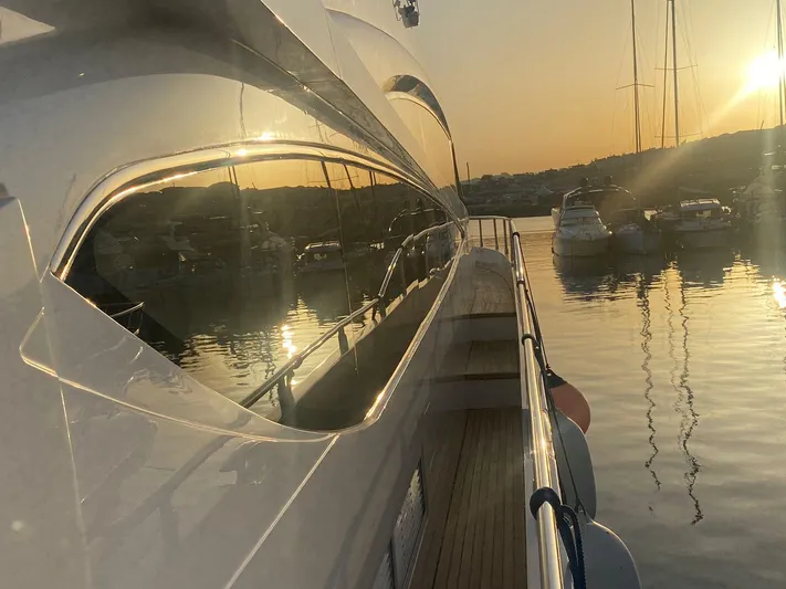 Vixen Yacht Photos Pics Luxurious 2011 Princess 85 Motor Yacht at sunset, reflecting on calm waters.