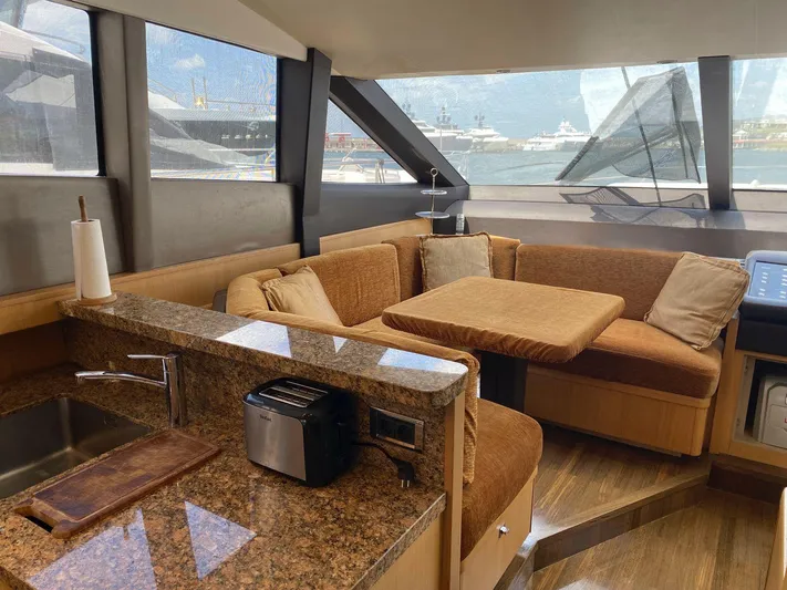 Vixen Yacht Photos Pics Luxurious interior of 2011 Princess 85 Motor Yacht with cozy seating and modern kitchen amenities.