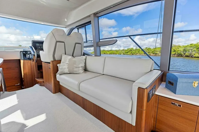 Twin Magic Yacht Photos Pics Luxurious interior of 2025 Princess F50 yacht with elegant seating and scenic water view.