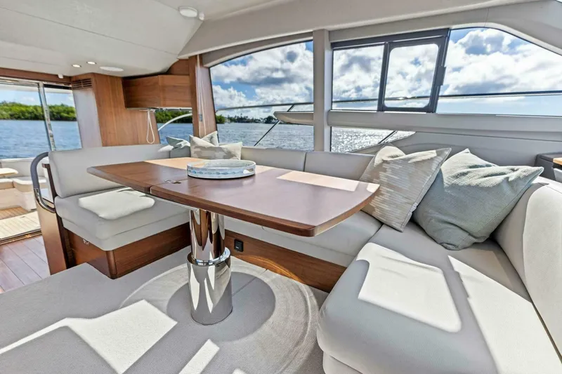 Twin Magic Yacht Photos Pics Luxurious interior of 2025 Princess F50 yacht with elegant seating and scenic water view.