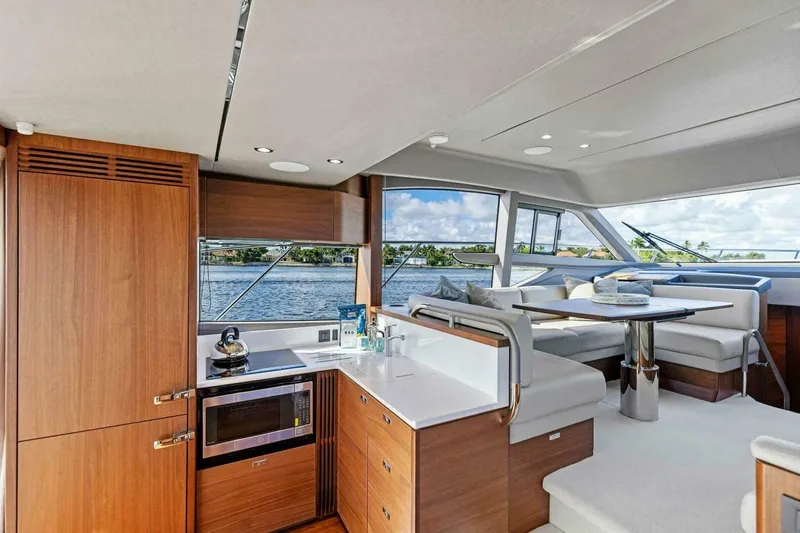 Twin Magic Yacht Photos Pics Luxurious interior of 2025 Princess F50 yacht with modern kitchen and dining area.