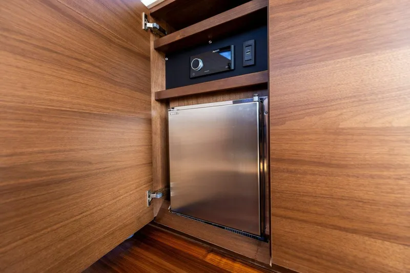 Twin Magic Yacht Photos Pics Wooden cabinet with a built-in stainless steel fridge on a Princess F50 yacht, 2025 model.