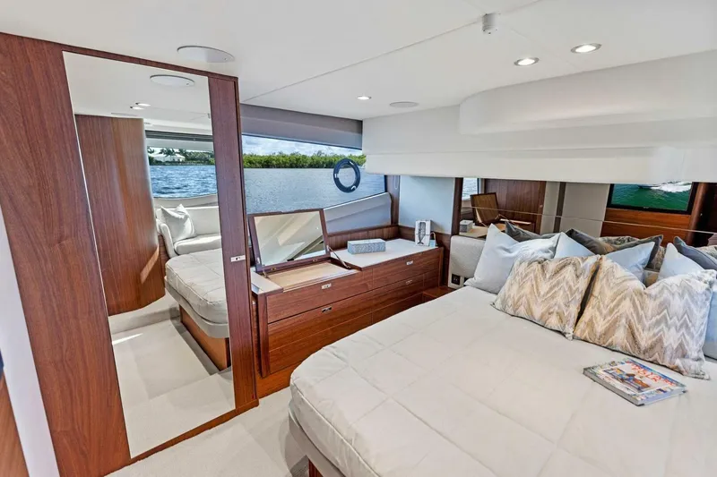 Twin Magic Yacht Photos Pics Luxurious 2025 Princess F50 yacht interior with elegant bedroom and scenic water view.