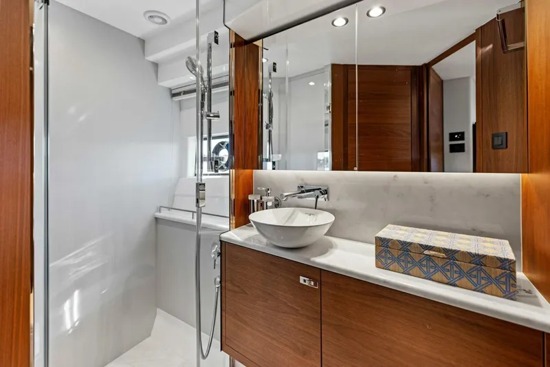 Twin Magic Yacht Photos Pics Luxurious bathroom in 2025 Princess F50 yacht with modern fixtures and elegant wood accents.