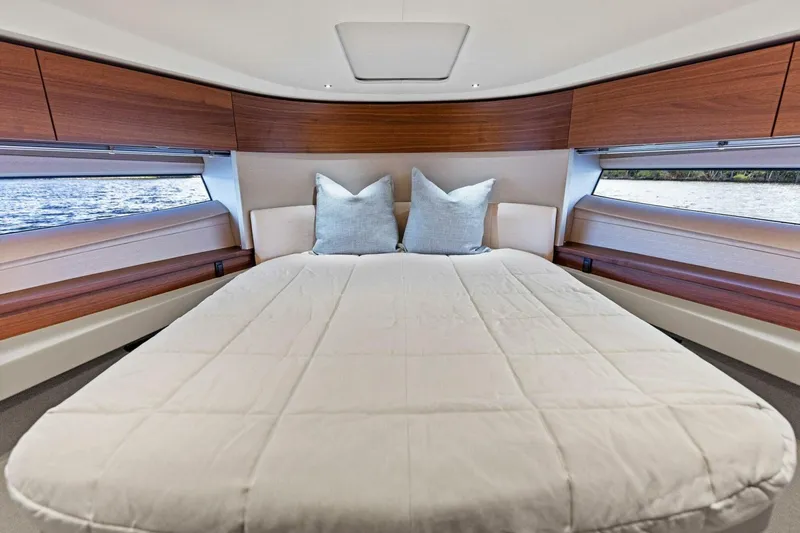Twin Magic Yacht Photos Pics Luxurious cabin interior of 2025 Princess F50 yacht with elegant bedding and wood accents.