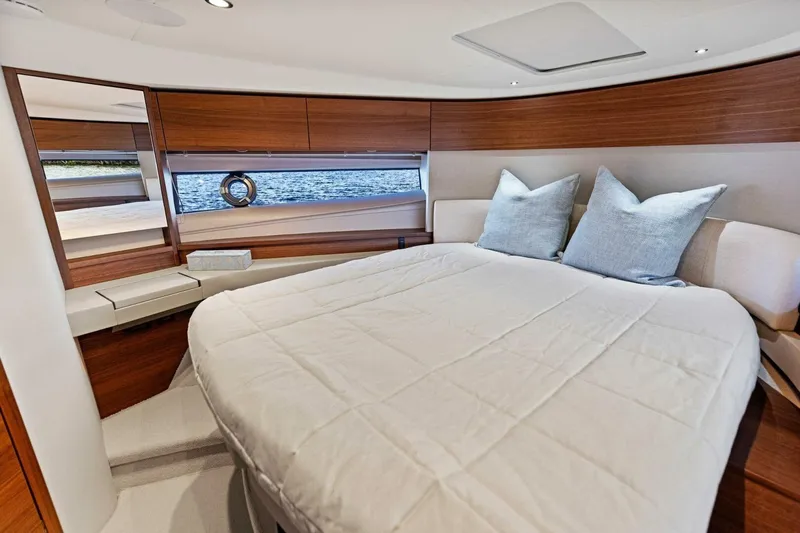 Twin Magic Yacht Photos Pics Luxurious cabin interior of 2025 Princess F50 yacht with elegant bedding and wood accents.