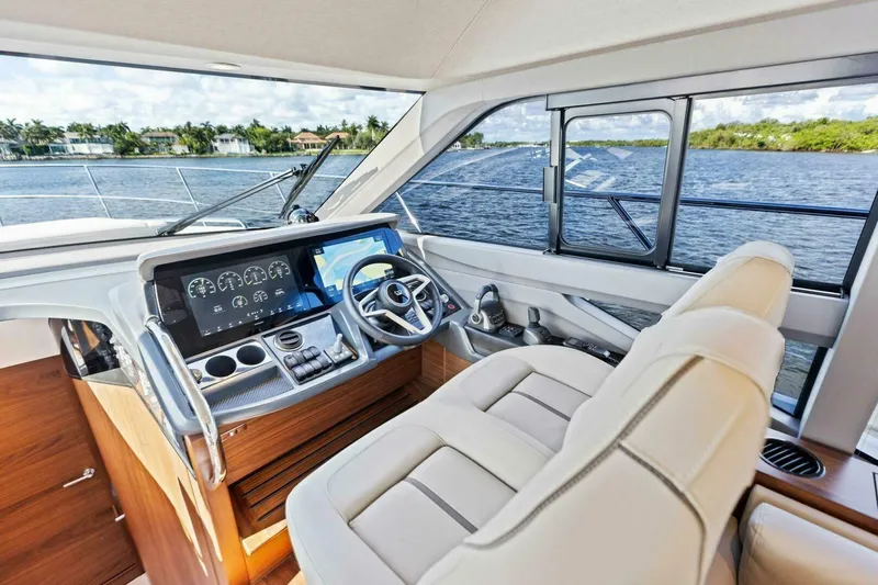 Twin Magic Yacht Photos Pics Luxurious 2025 Princess F50 yacht cockpit with modern controls and panoramic water view.