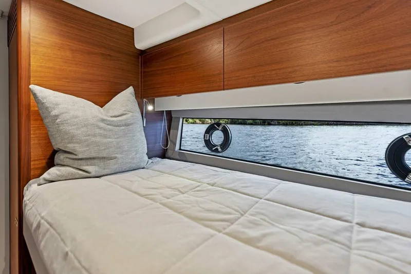 Twin Magic Yacht Photos Pics Luxurious cabin interior of 2025 Princess F50 yacht with wooden finish and water view.
