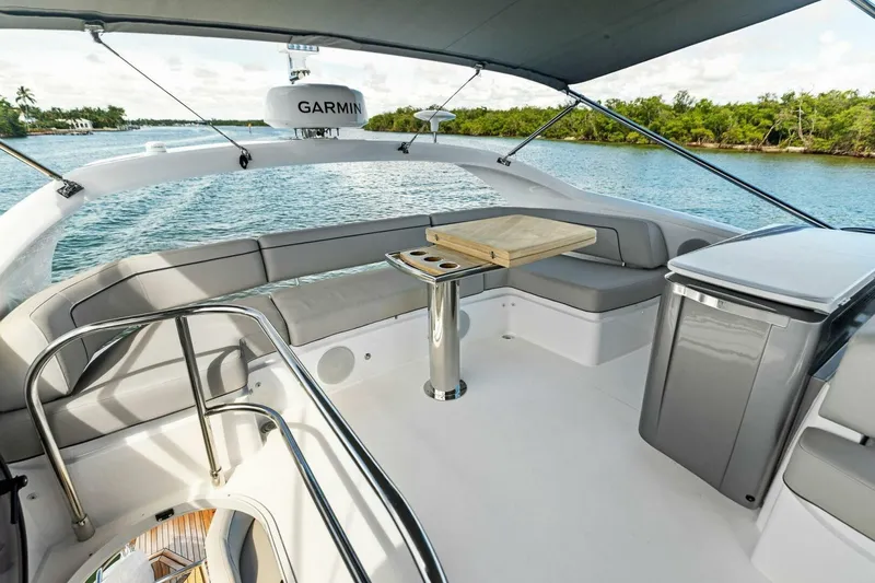 Twin Magic Yacht Photos Pics Luxurious 2025 Princess F50 yacht deck with seating, table, and scenic water view.