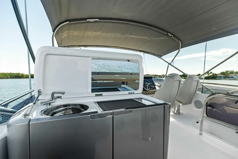 Twin Magic Yacht Photos Pics Luxury yacht Princess F50 2025 with outdoor kitchen and seating area.