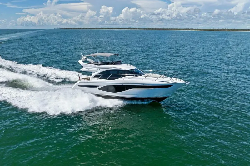 Twin Magic Yacht Photos Pics Luxurious 2025 Princess F50 yacht cruising on open sea under clear skies.