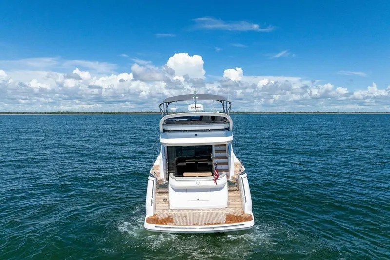Twin Magic Yacht Photos Pics 2025 Princess F50 yacht cruising on open sea under clear blue sky.