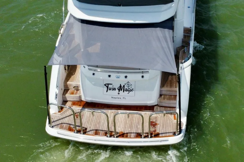 Twin Magic Yacht Photos Pics Aerial view of 2025 Princess F50 yacht "Twin Magic" cruising in green waters.