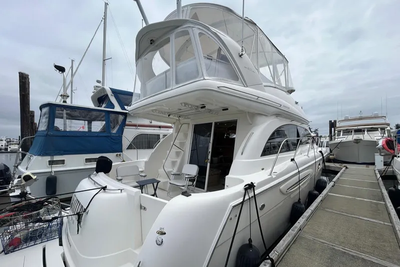 Yacht Photos Pics 2004 Meridian 411 Sedan yacht docked at marina, featuring spacious upper deck and sleek design.