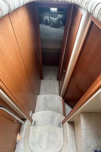  Yacht Photos Pics Interior view of 2004 Meridian 411 Sedan yacht with carpeted stairs and wooden paneling.