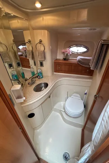  Yacht Photos Pics Luxurious bathroom in 2004 Meridian 411 Sedan yacht with modern amenities and elegant design.