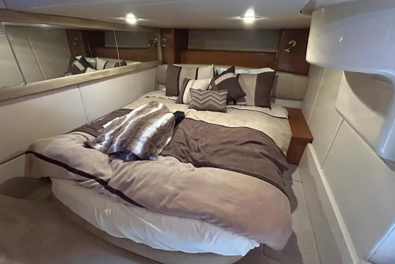  Yacht Photos Pics Luxurious bedroom interior of 2004 Meridian 411 Sedan yacht with plush bedding and ambient lighting.