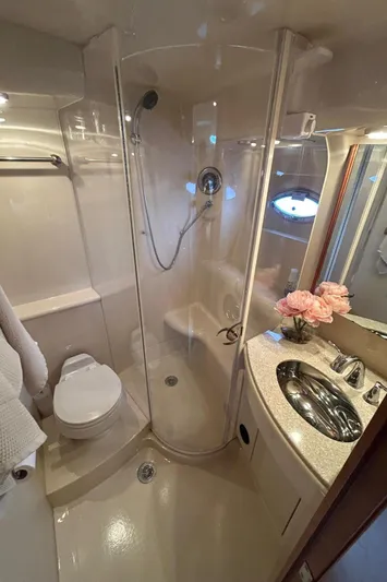  Yacht Photos Pics Luxurious bathroom in 2004 Meridian 411 Sedan yacht with shower, sink, and elegant decor.
