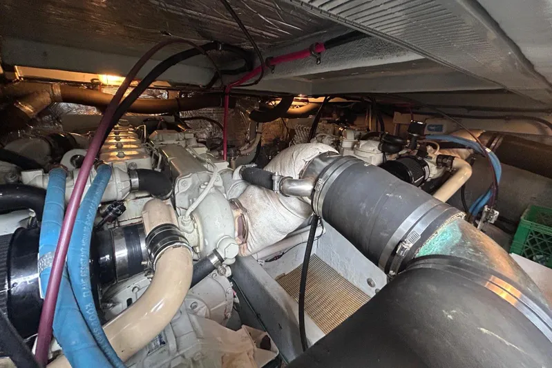  Yacht Photos Pics Engine room of a 2004 Meridian 411 Sedan with visible pipes and machinery.