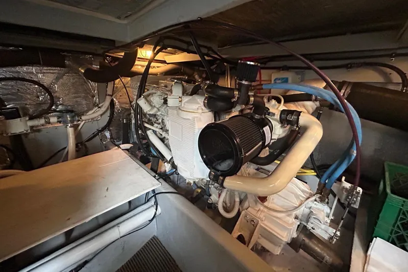  Yacht Photos Pics Engine room of a 2004 Meridian 411 Sedan yacht, showcasing mechanical components and wiring.