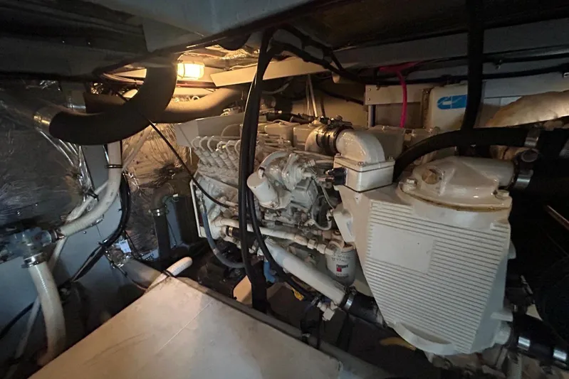  Yacht Photos Pics Engine room of a 2004 Meridian 411 Sedan yacht, showcasing mechanical components and piping.