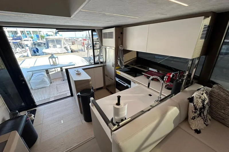  Yacht Photos Pics Luxurious 2023 Prestige 590 yacht interior with modern kitchen and marina view.