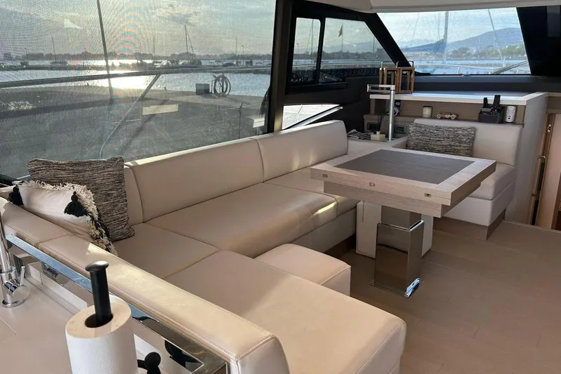  Yacht Photos Pics Luxurious interior of 2023 Prestige 590 yacht with elegant seating and table.