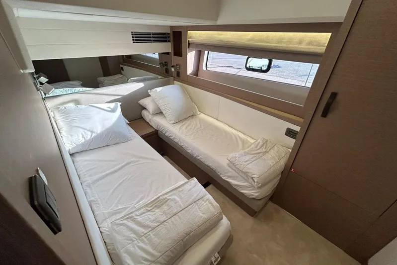  Yacht Photos Pics Luxurious twin cabin interior of 2023 Prestige 590 yacht, featuring modern design and comfortable bedding.