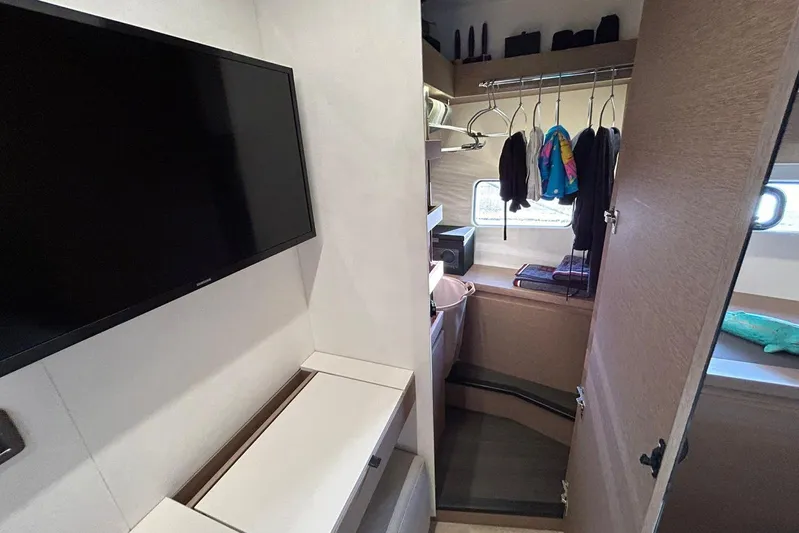  Yacht Photos Pics 2023 Prestige 590 yacht interior with TV, closet, and modern design elements.